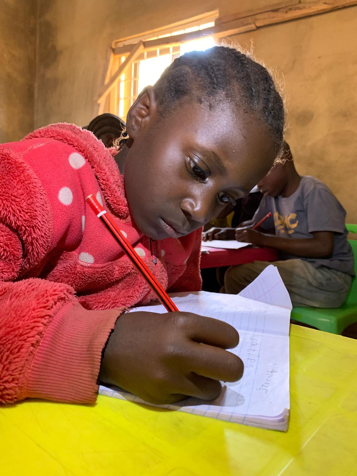 A girl concentrating on her writing