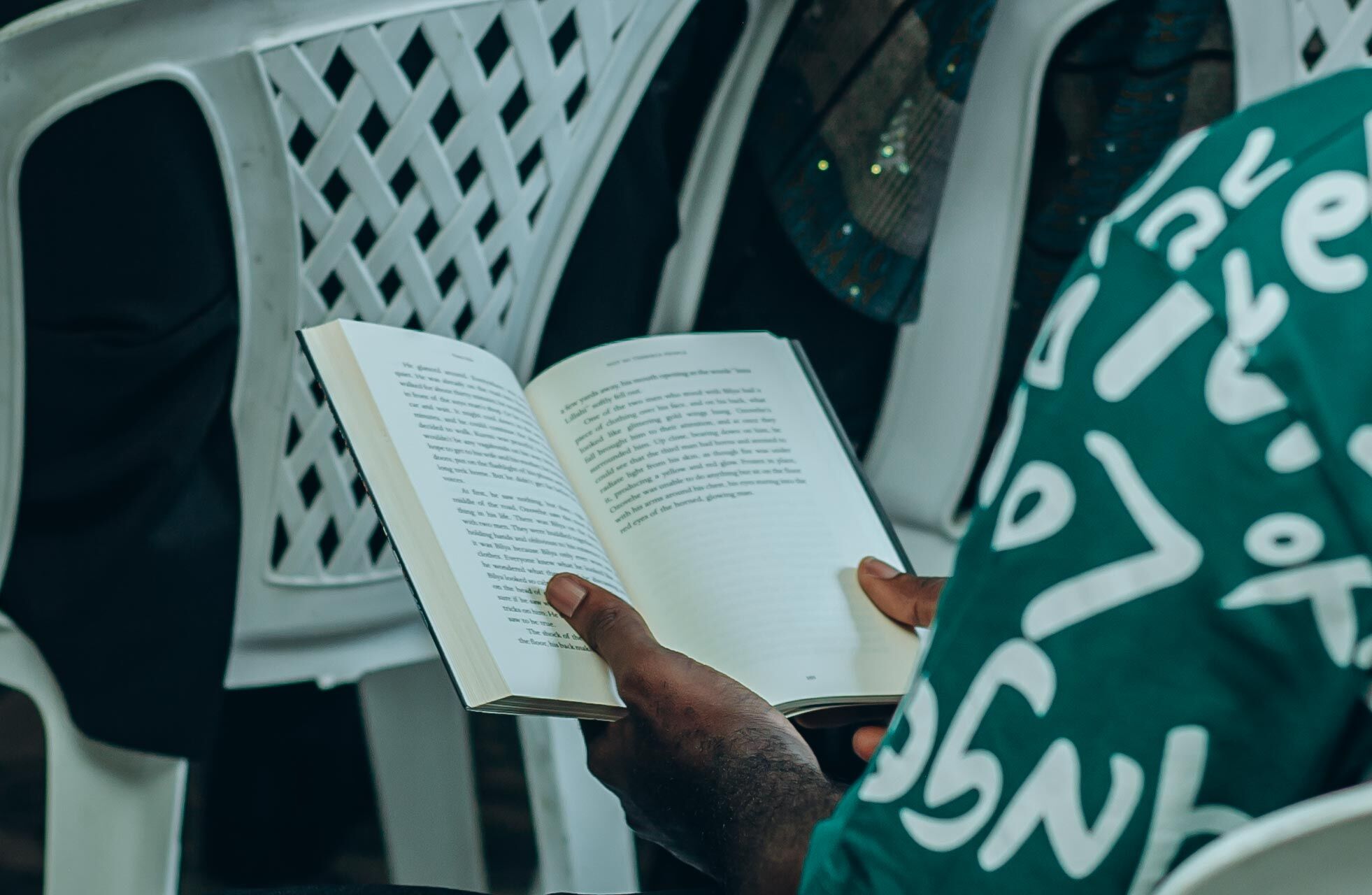 An open book in a reader's hands