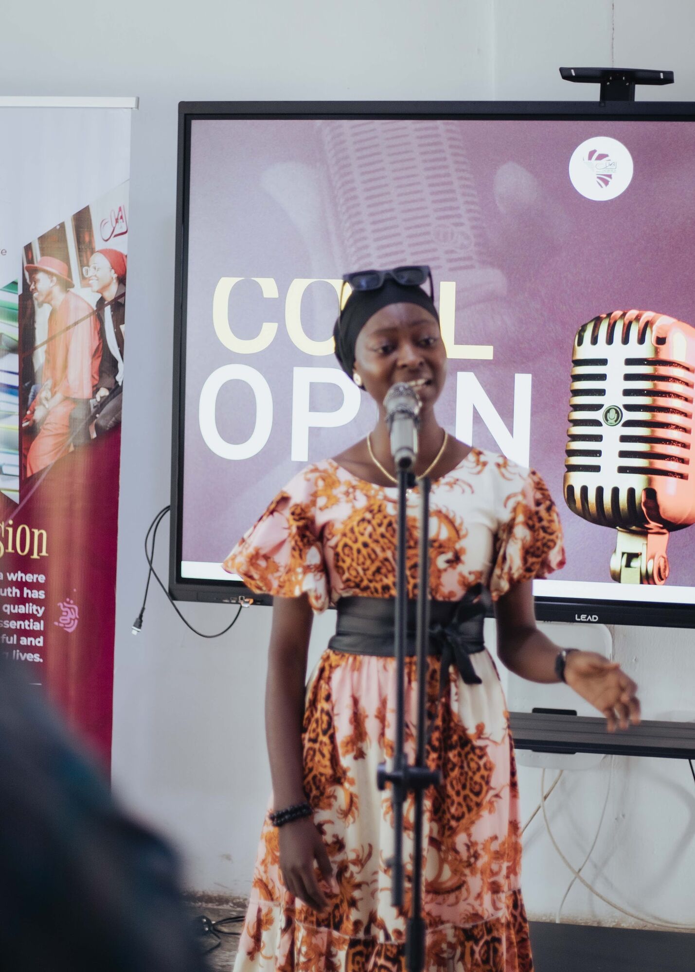 A singer performing on the COAL Open Mic stage