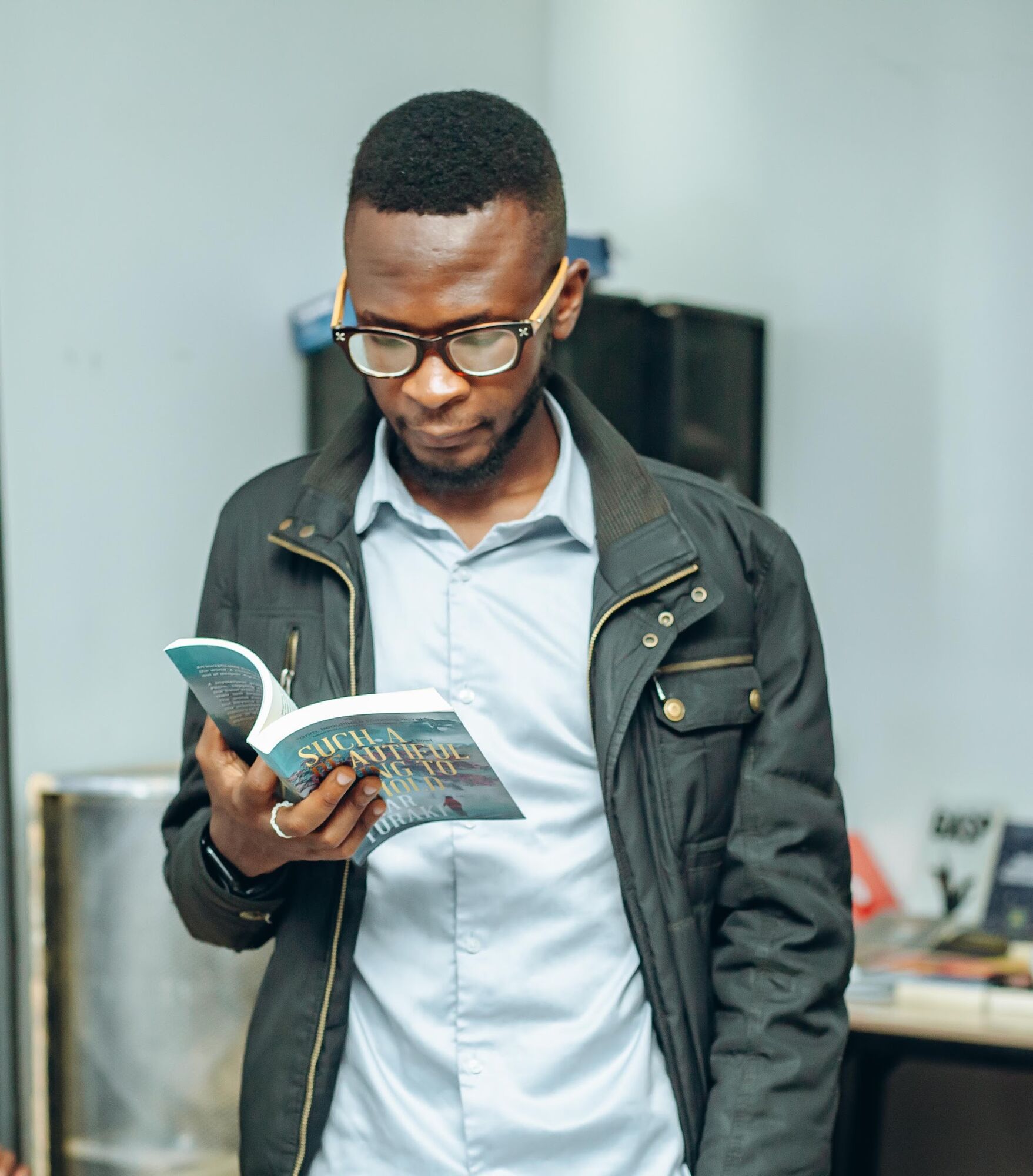 A young man reading at a COAL book reading